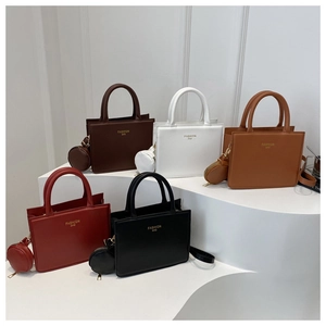 Detail view showing five colors of minimalist tote bags with round coin purses on stairs