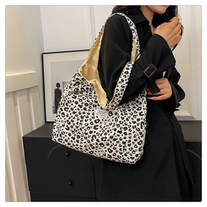 Close-up of black and white leopard print tote bag with stylish white fashion label detail