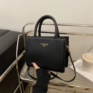 Classic black square handbag with gold lettering and top handles for stylish commuting