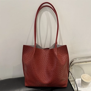 Deep red woven tote bag with long shoulder straps for stylish commuting and casual wear