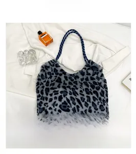 Detail of plush leopard print tote bag with durable braided blue and black rope handles
