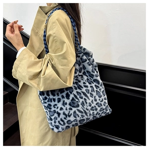 Detailed texture of leopard print faux fur tote bag with braided navy blue shoulder strap