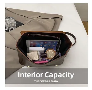 Detailed interior view of a brown leather backpack showing capacity for iPad and makeup