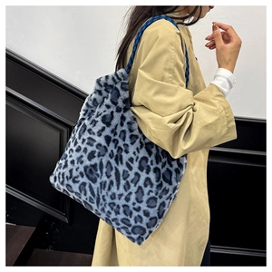 Detail of blue leopard print faux fur tote bag with braided rope shoulder strap