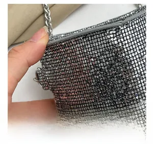 Detailed view of silver rhinestone handbag showing precise stitching and metallic mesh