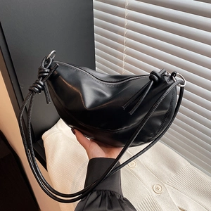 Minimalist black crescent shoulder bag with knotted strap and silver ring hardware