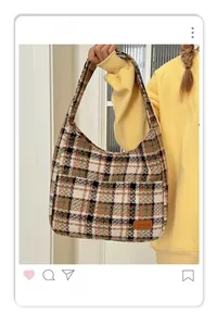 Detail of vintage plaid tote bag featuring checkered wool texture and leather logo patch