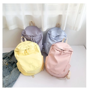 Group shot of lightweight nylon backpacks in pastel purple, blue, yellow, and pink colors