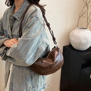 Minimalist dark brown croissant hobo bag with knotted shoulder strap detail for women