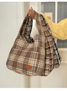 Three oversized plaid tote bags in brown, green, and grey featuring fashion leather patches