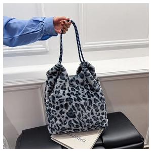 Close-up of leopard faux fur texture and dual-tone braided rope handles on tote bag