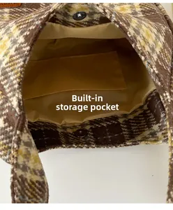 Detail view of plaid canvas tote bag showing interior lining and inner storage pocket