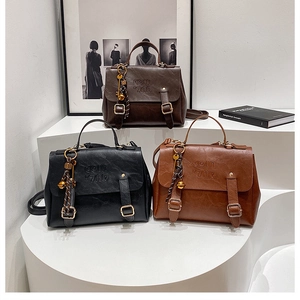 Detailed view of vintage leather backpacks in dark brown, black, and caramel colors