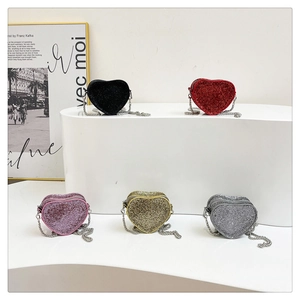 Sparkly heart shaped evening clutch bags with colorful rhinestones and chain straps