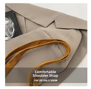 Macro view of a comfortable corduroy shoulder strap on a beige casual tote bag
