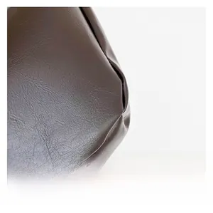 Dettaglio macro in pelle PU marrone scuro con trama a grana fine e cuciture di qualità