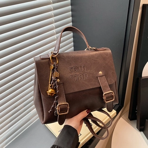 Vintage dark brown faux leather backpack for women with metal charms and retro logo