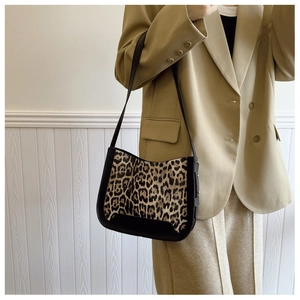 Detail view of vintage leopard print patchwork texture on a stylish underarm shoulder bag