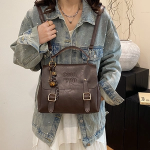 Vintage dark brown PU leather backpack for women with decorative straps and artistic charm