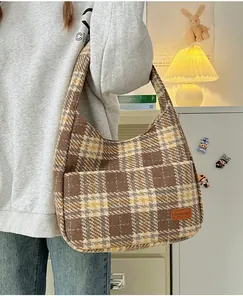 Plaid vintage tote bag with fashion leather patch and front pocket shown on shoulder