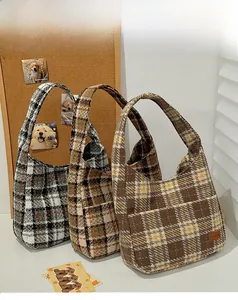 Detailed view of retro plaid hobo bags with textured knit fabric and side pockets