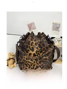 Detail view of the drawstring bucket bag back featuring vintage leopard print patterns