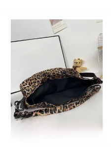 Detail view of the leopard print bucket bag's spacious interior with black fabric lining