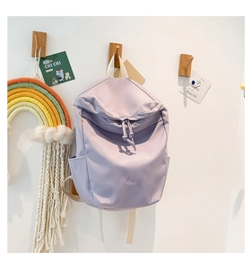 Detail view of purple nylon backpack with smooth zipper and front B.a.g lettering print