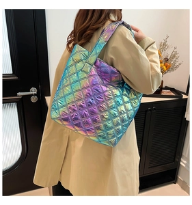 Dettaglio della borsa tote trapuntata con finitura olografica e trench coat beige