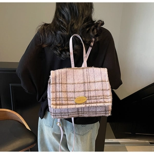 Détail du sac à dos en tweed lilas avec plaque en métal doré et motif à carreaux chic