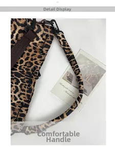 Detail view of the leopard print bucket bag featuring comfortable handles and metallic D-rings
