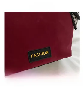 Detail view of burgundy frosted tote bag with fashion logo and geometric silk scarf