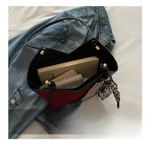 Detail showing high-capacity interior of red and black tote bag with silk scarf