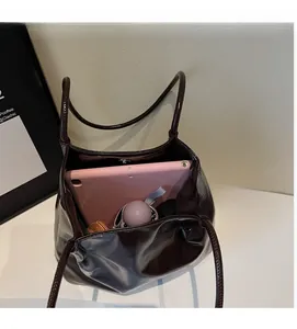 Detail view of the spacious inner compartment of the dark brown leather tote bag