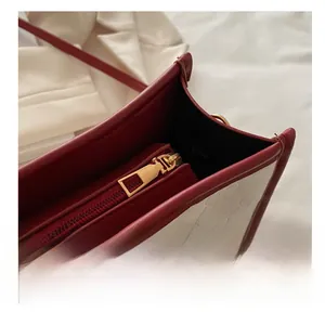 Detail of gold metal zipper and floral embossed texture on contrast tote bag