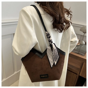Brown suede tote bag with silk scarf detail and black leather trim on model