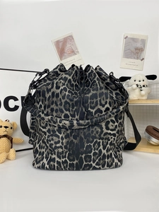 Detailed view of the leopard print PU leather bucket bag with adjustable black strap