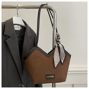 Brown suede tote bag detail with V-shaped opening, silk scarf and Fashion label