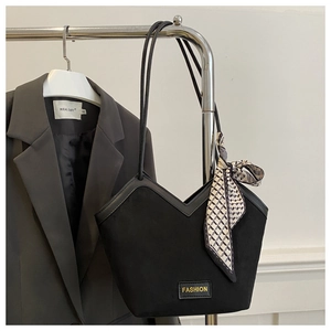 Detail view of black V-cut tote bag featuring a decorative silk scarf on the handle