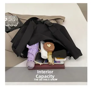 Top view showing large interior capacity of this black crossbody bag with daily essentials