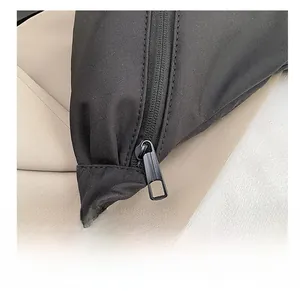Detail shot of smooth black nylon material and high-quality metal zipper on the shoulder bag