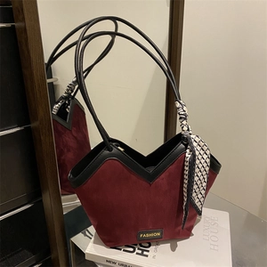 Burgundy faux suede tote bag with black V-shaped trim and silk scarf accessory