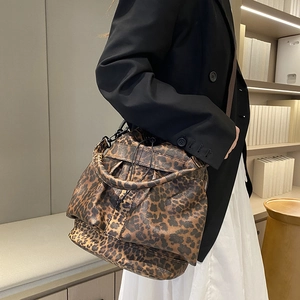 Chic leopard print bucket bag with drawstring closure and stylish round top handle