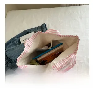 Detail view of pink striped canvas tote bag interior with large capacity pockets