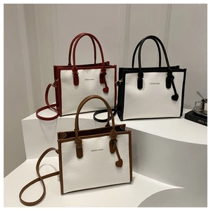 Detailed view of color-block tote bags with bow-embossed pattern and heart charms