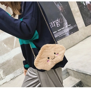 Detail of khaki plush cloud shoulder bag with embroidered smiley face and gold chain strap