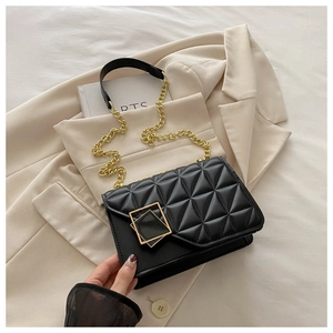 Détail du sac bandoulière noir matelassé avec surpiqûres et boucle carrée dorée