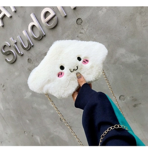 Close-up of white plush cloud-shaped crossbody bag with cute facial embroidery and gold chain