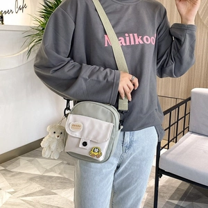 Mini nylon canvas crossbody bag in Morandi green with cute bear charm and cartoon patches