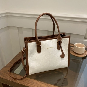 Contrast stitching tote bag with bow embossing and brown handles for daily commute
